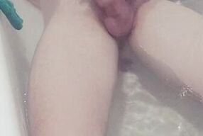 Lying in the bath playing and smoking