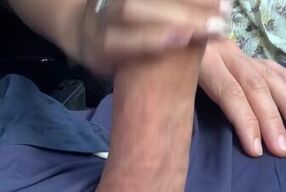 Chinese babe jerks off big white cock while driving